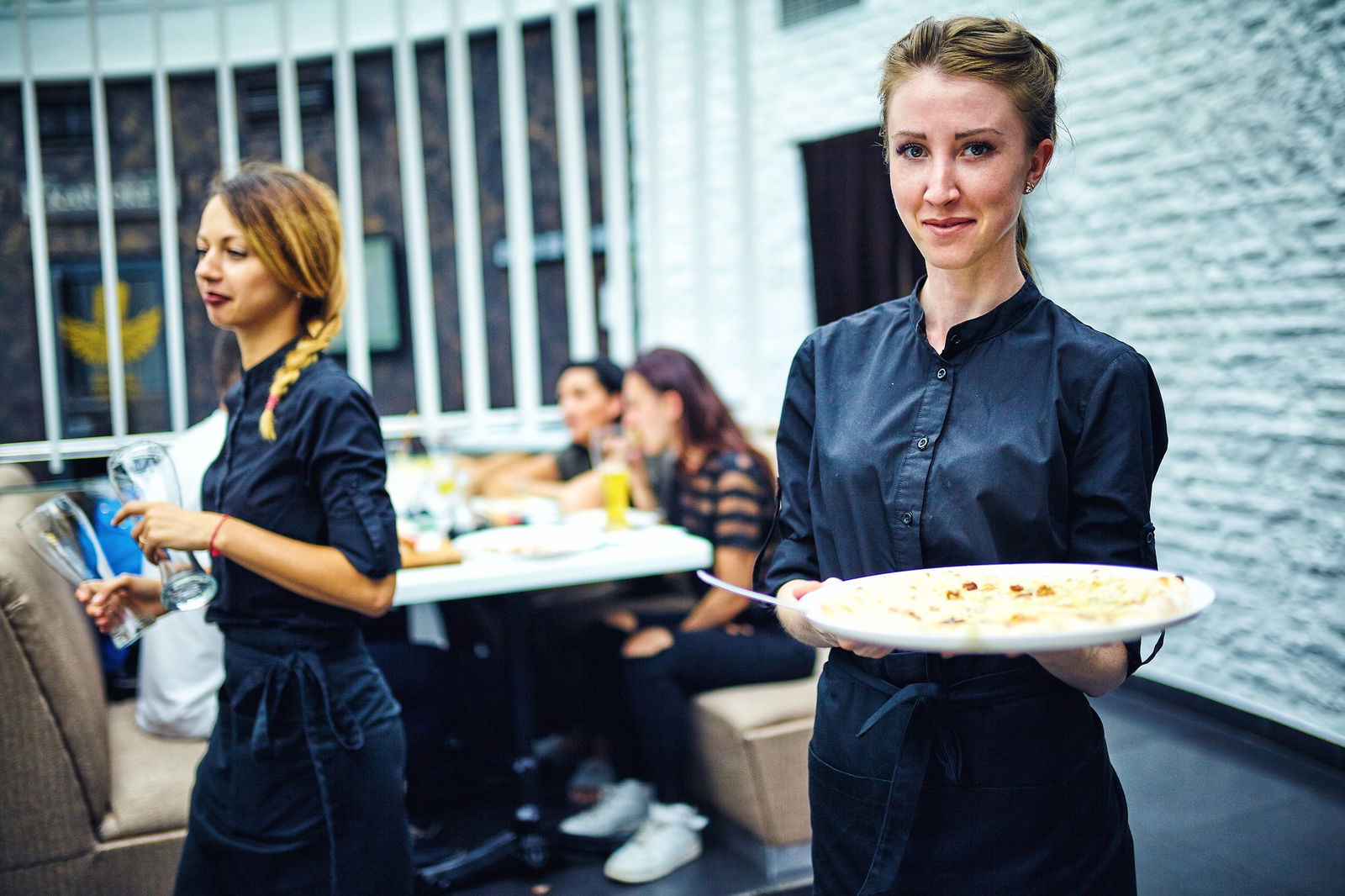 Hospitality worker serving a plate of food