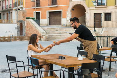 Waitress and a guest on the terrace