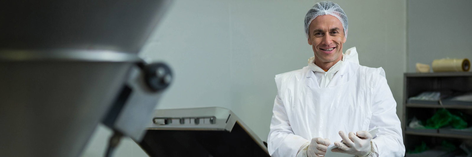 Worker with a tablet in a production hall