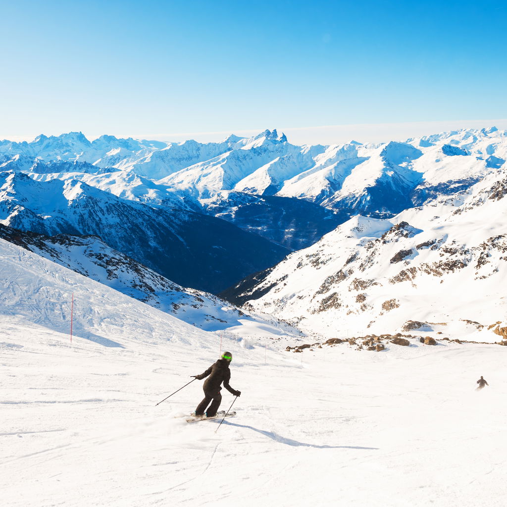 Skier rides down slop French Alps