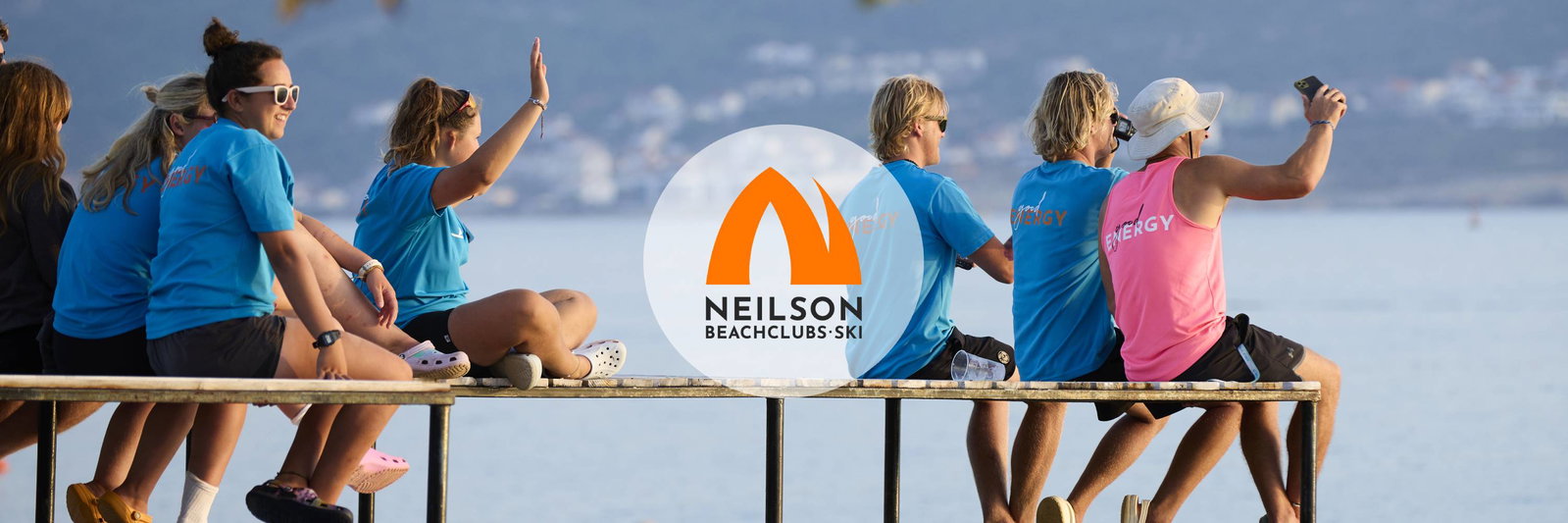 Employees sitting on the side of the sea at sunny day