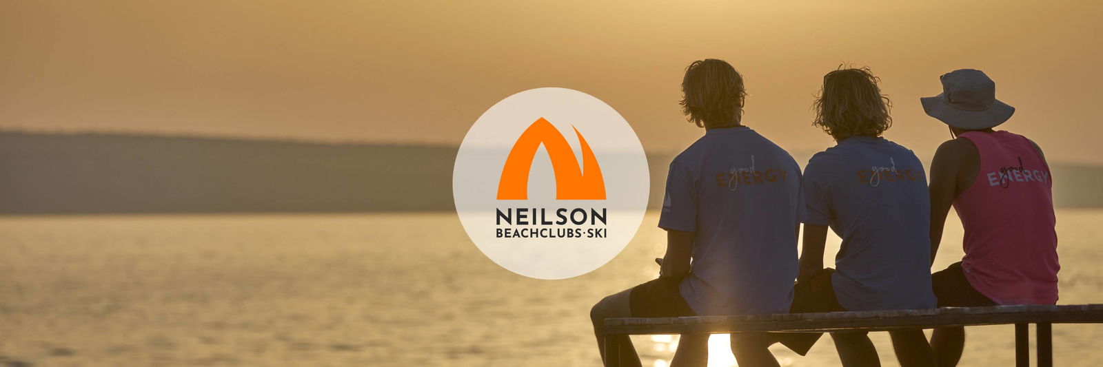 Three employees of a beach resort watching the sunset