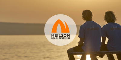 Three employees of a beach resort watching the sunset