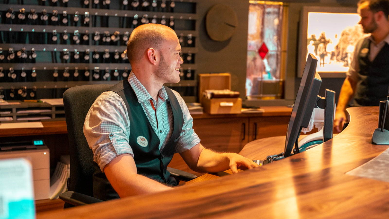 Man die werkt bij de receptie van een hotel