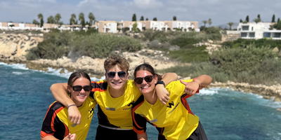 Team photo of entertainers with the sea in the background