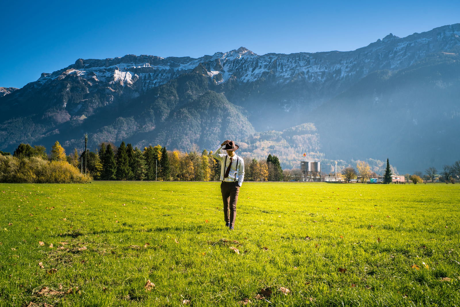 Man grass field by mountain switzerland