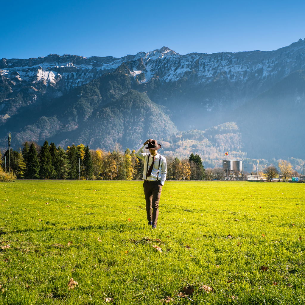 Man grass field by mountain switzerland