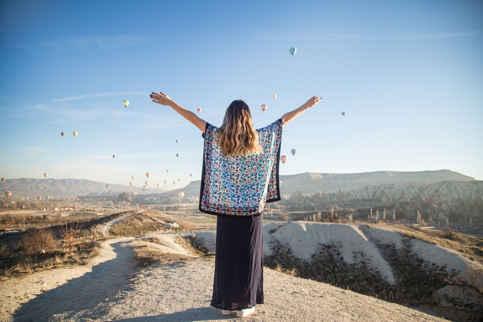 Woman enjoying vacation in Turkey with balloons in the sky