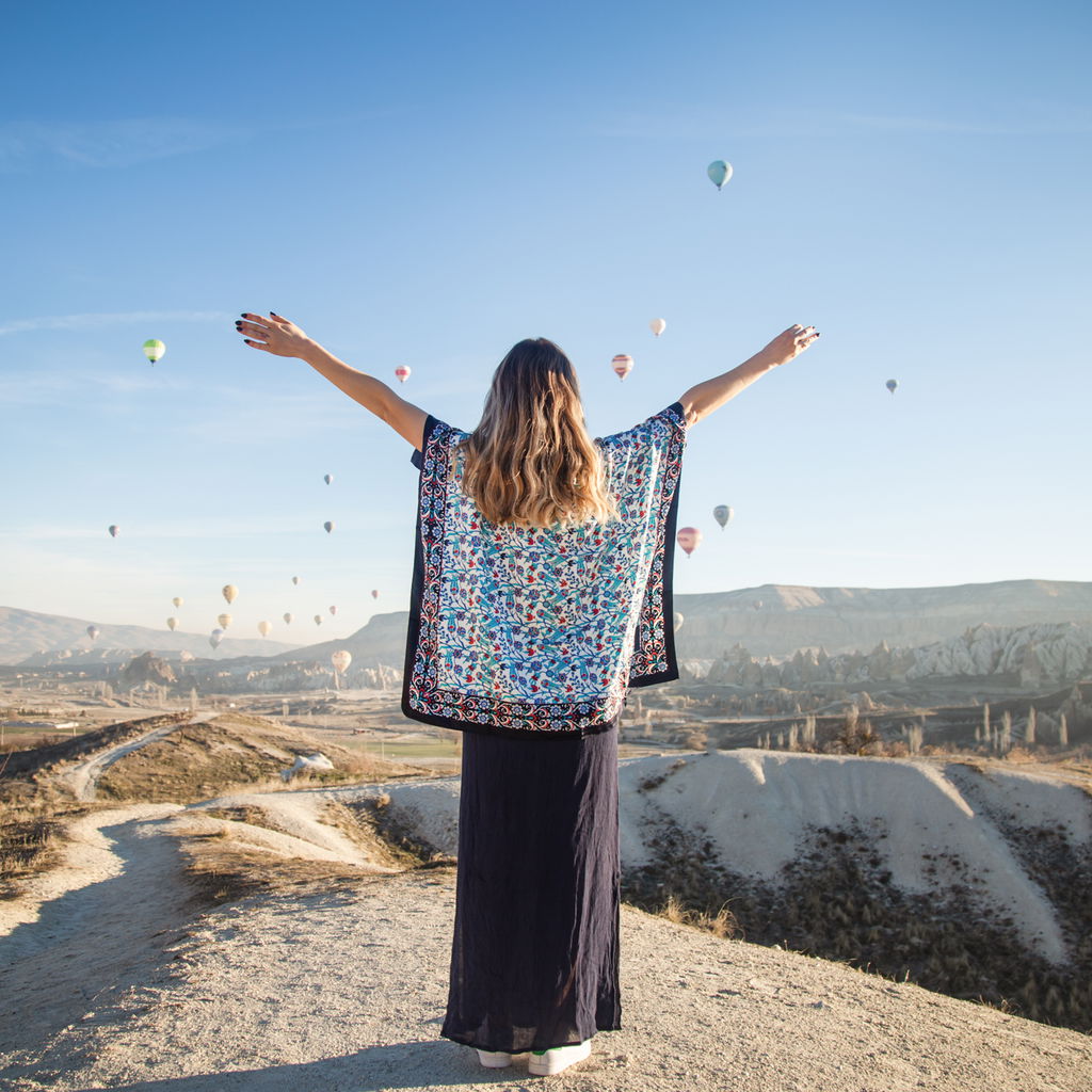 Woman enjoying vacation in Turkey with balloons in the sky