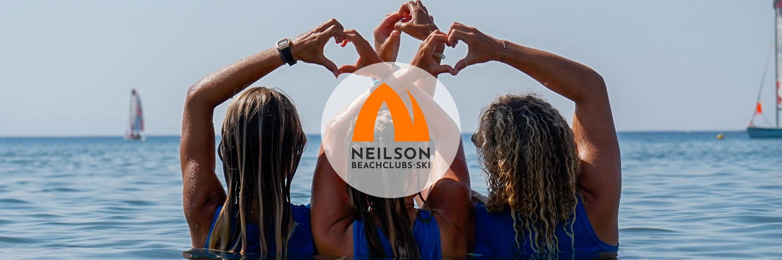 Three woman forming a heart in the sea