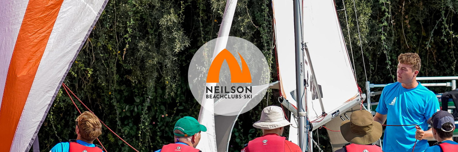 Sail instructor with students on a sunny day