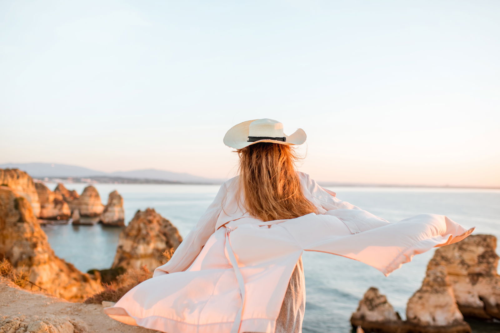 Woman enjoying great rocky view sunrise portugal
