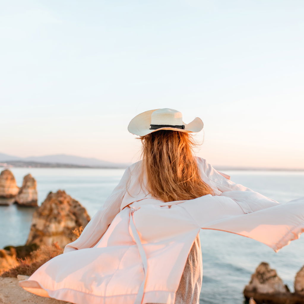 Woman enjoying great rocky view sunrise portugal